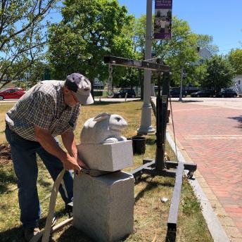 Thomas Berger, sculptor, is straightening his sculpture.